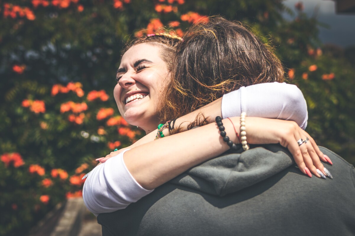 smiling woman hugging another person 2292932 Urban Decay Naked Honey Saying Something Truly Important Can Require More Than Just Words