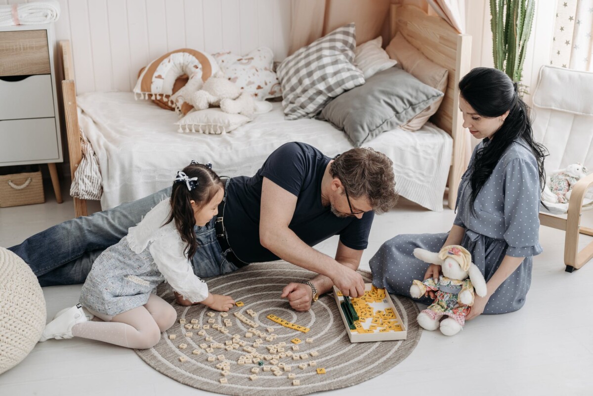 a happy foster family playing scrabble