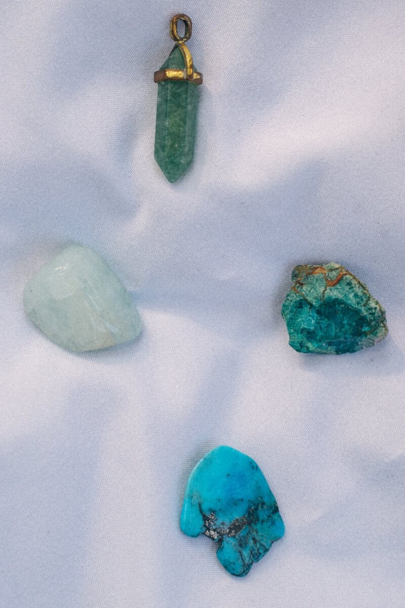 various gemstones on white textile
