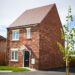 brown brick building near green grass field during daytime