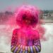 person having pink spray on hair during daytime