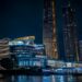 Modern illuminated buildings at night by the water