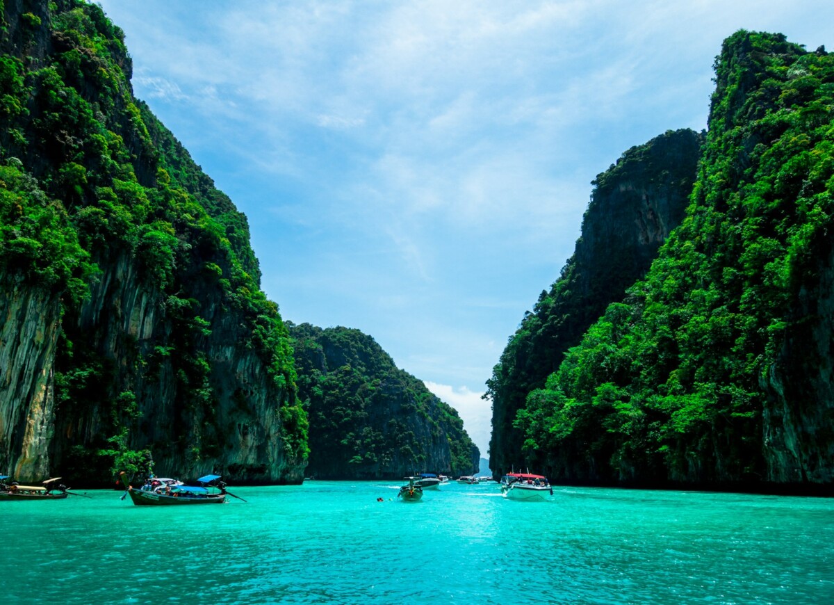 boats on sea near mountain during daytime